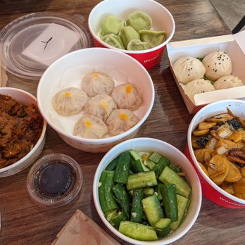 Nan Xiang Express  - (clockwise from top) dumplings of sorts, pan fried buns, veggie rice cake, chilled cucumber, chili beef. - Shanghainese Near Me - Boston, Massachusetts