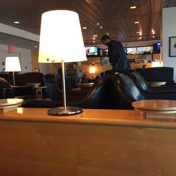 United Club - a man standing in the lounge area - Airport Lounges Near Me - Flushing, New York