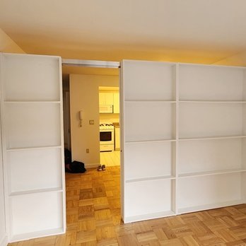 NYC Interior Remodeling - Freestanding bookcase with sliding door and 5 inch shelves. - General Contractors Near Me - New York, New York NYC Interior Remodeling - Freestanding bookcase with sliding door and 5 inch shelves. - General Contractors Near Me - New York, New York