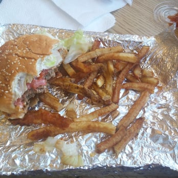 Five Guys - Half eaten regular burger and regular fries.  I dug in and then thought about a picture! - Burgers Near Me - Ewing, New Jersey