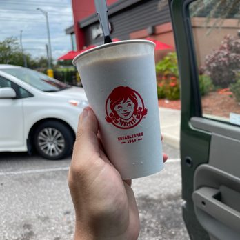 Wendy's - a hand holding a cup of coffee - Fast Food Near Me - Lakeland, Florida