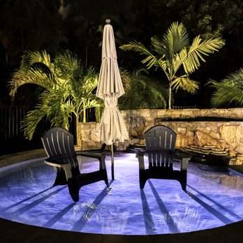 Treasurescapes - two chairs and an umbrella in a pool - Landscape Architects or Designers Near Me - Boynton Beach, Florida Treasurescapes - two chairs and an umbrella in a pool - Landscape Architects or Designers Near Me - Boynton Beach, Florida