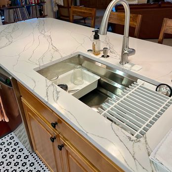 Distinctive Tile & Stone - a kitchen countertop with a sink and faucet - General Contractors Near Me - Olympia, Washington