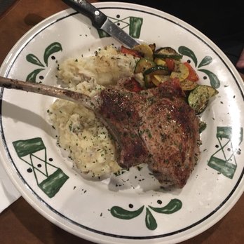 The Howling Rooster - Tomahawk pork chop with real mashed potatoes and vegetables. - Breakfast & Brunch Near Me - Buffalo, New York The Howling Rooster - Tomahawk pork chop with real mashed potatoes and vegetables. - Breakfast & Brunch Near Me - Buffalo, New York