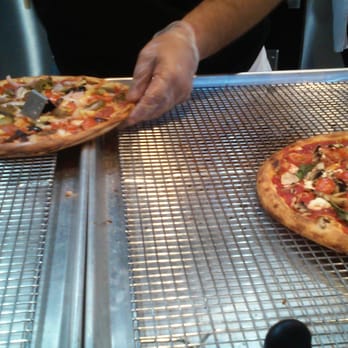 Blaze Pizza - Pizza being sliced up. - Salad Near Me - Orange, California