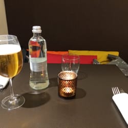 At table waiting for food and enjoying a beer.