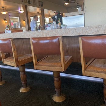 Depot Grill And Catering - a row of wooden chairs in a restaurant - American Near Me - Twin Falls, Idaho Depot Grill And Catering - a row of wooden chairs in a restaurant - American Near Me - Twin Falls, Idaho