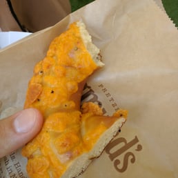 a person holding a piece of pizza a person holding a piece of pizza