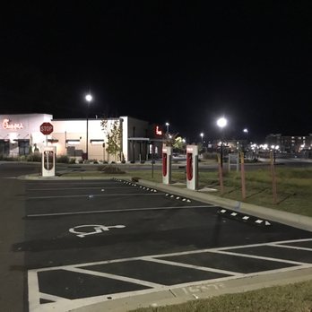Tesla Supercharger - 4 Stalls of 10 250kW with Chick-Fila in background - EV Charging Stations Near Me - Chapel Hill, North Carolina Tesla Supercharger - 4 Stalls of 10 250kW with Chick-Fila in background - EV Charging Stations Near Me - Chapel Hill, North Carolina