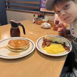 Josiah, my nephew, enjoying his combo with all bacon. Six pieces of bacon, hash browns, scrambled eggs with cheese, and pancakes. Josiah, my nephew, enjoying his combo with all bacon. Six pieces of bacon, hash browns, scrambled eggs with cheese, and pancakes.