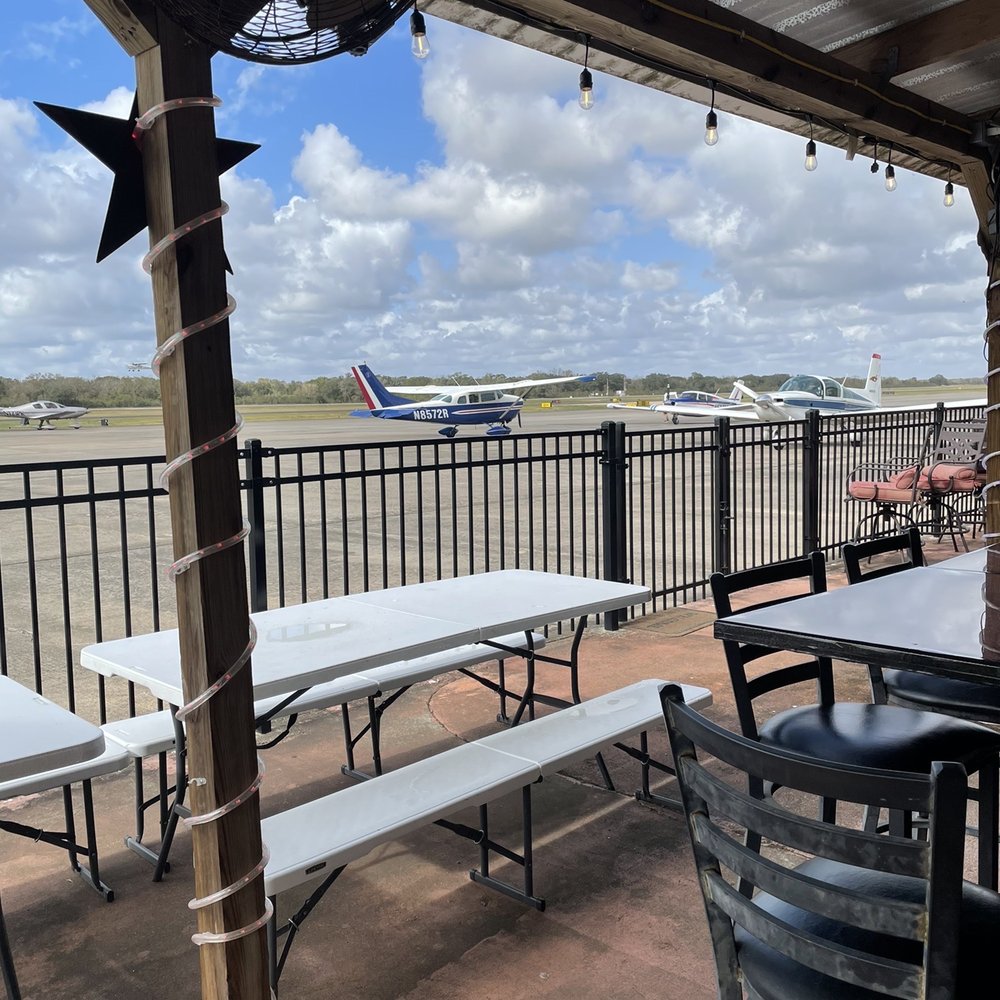 Runway Cafe - On the patio area watching the planes park to come eat at the restaurant. - Seafood Near Me - Angleton, Texas Runway Cafe - On the patio area watching the planes park to come eat at the restaurant. - Seafood Near Me - Angleton, Texas