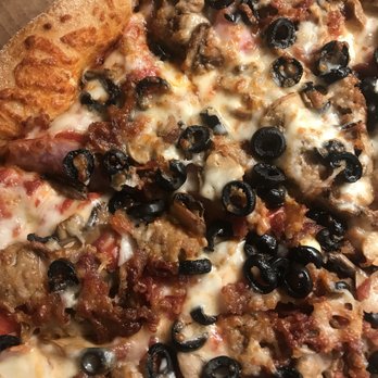 Marco's Pizza - a pizza with meat, olives, and cheese - Pizza Near Me - Newnan, Georgia