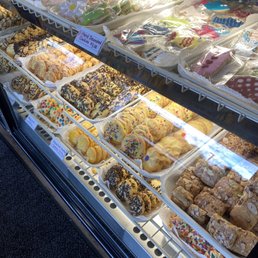 a variety of donuts in a display case