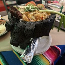 Steak and Shrimp Molcajeta with Queso Fundito on top. Steak and Shrimp Molcajeta with Queso Fundito on top.