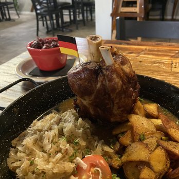 Restaurant Edelweiss - Pork shank with sauerkraut, red cabbage and fried potatoes - German Near Me - Bradenton, Florida Restaurant Edelweiss - Pork shank with sauerkraut, red cabbage and fried potatoes - German Near Me - Bradenton, Florida