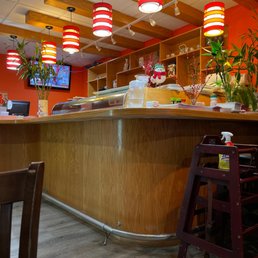 a restaurant with a counter and chairs