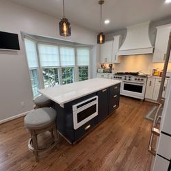 Floors Kitchen & Bath Direct - Beautiful kitchen renovation with a multicolor cabinet style and a custom made hood.