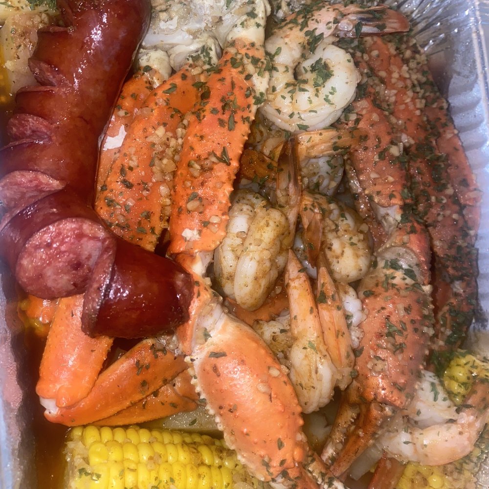 shrimp, crab legs, corn on the cob, and sausage shrimp, crab legs, corn on the cob, and sausage