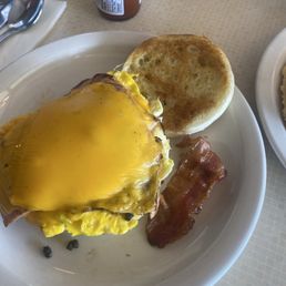 cabin muffin  delicious, egg, thick slice ham inside, cheesy overhang. lol