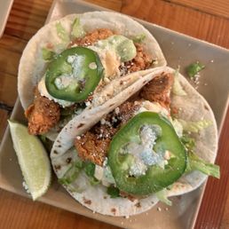 Happy hour : FRIED CHICKEN TACOS lettuce, pico de gallo, cotja, avocado crema, jalapeno, chipotle lime ranch, flour tortilla $10 for 2 Happy hour : FRIED CHICKEN TACOS lettuce, pico de gallo, cotja, avocado crema, jalapeno, chipotle lime ranch, flour tortilla $10 for 2