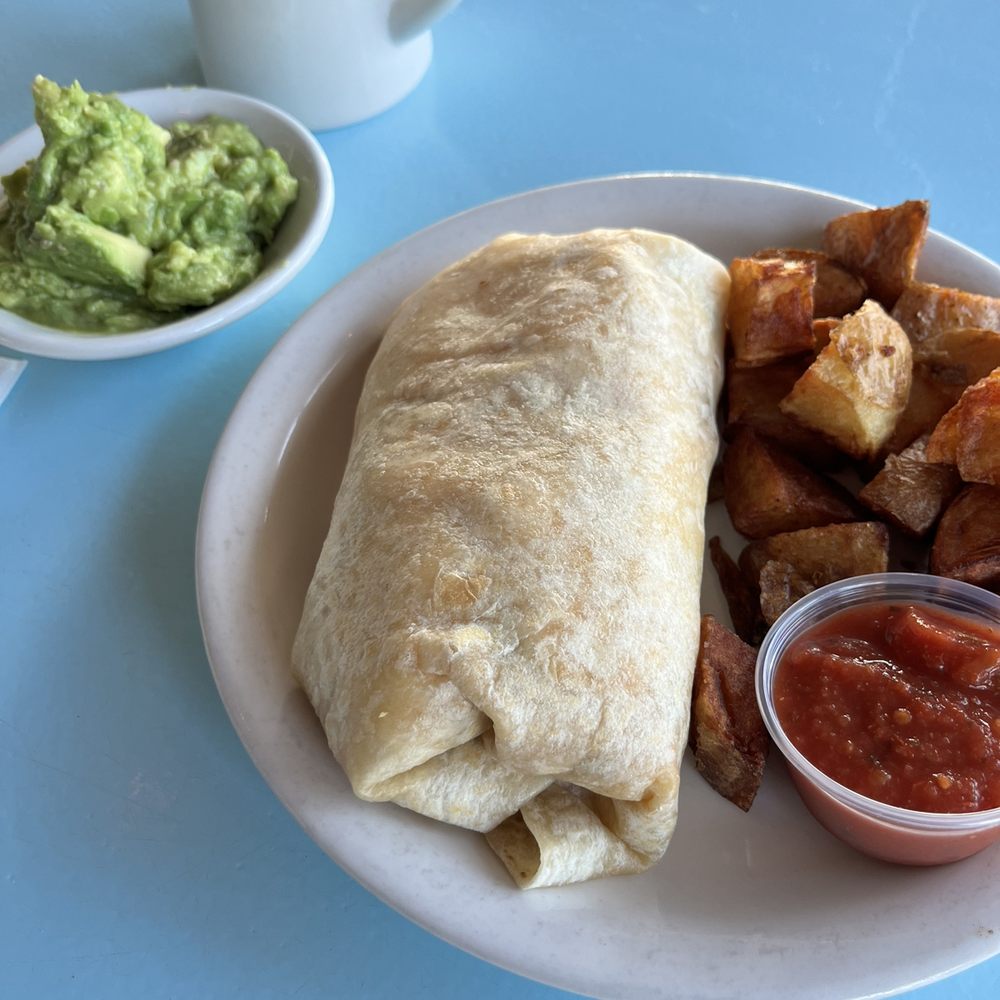 Breakfast burrito with pork roll, home fries and a side of avocado. Breakfast burrito with pork roll, home fries and a side of avocado.