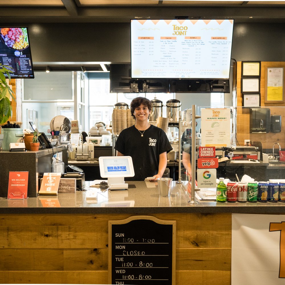 a man behind the counter a man behind the counter