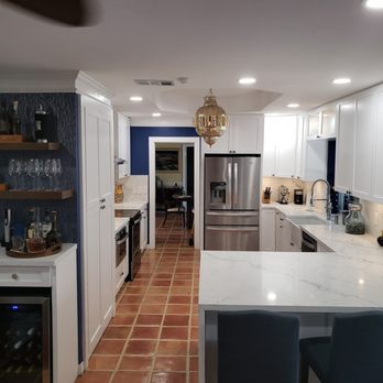 Miami Kitchens & More - a kitchen with white cabinets and blue walls - General Contractors Near Me - Miami, Florida