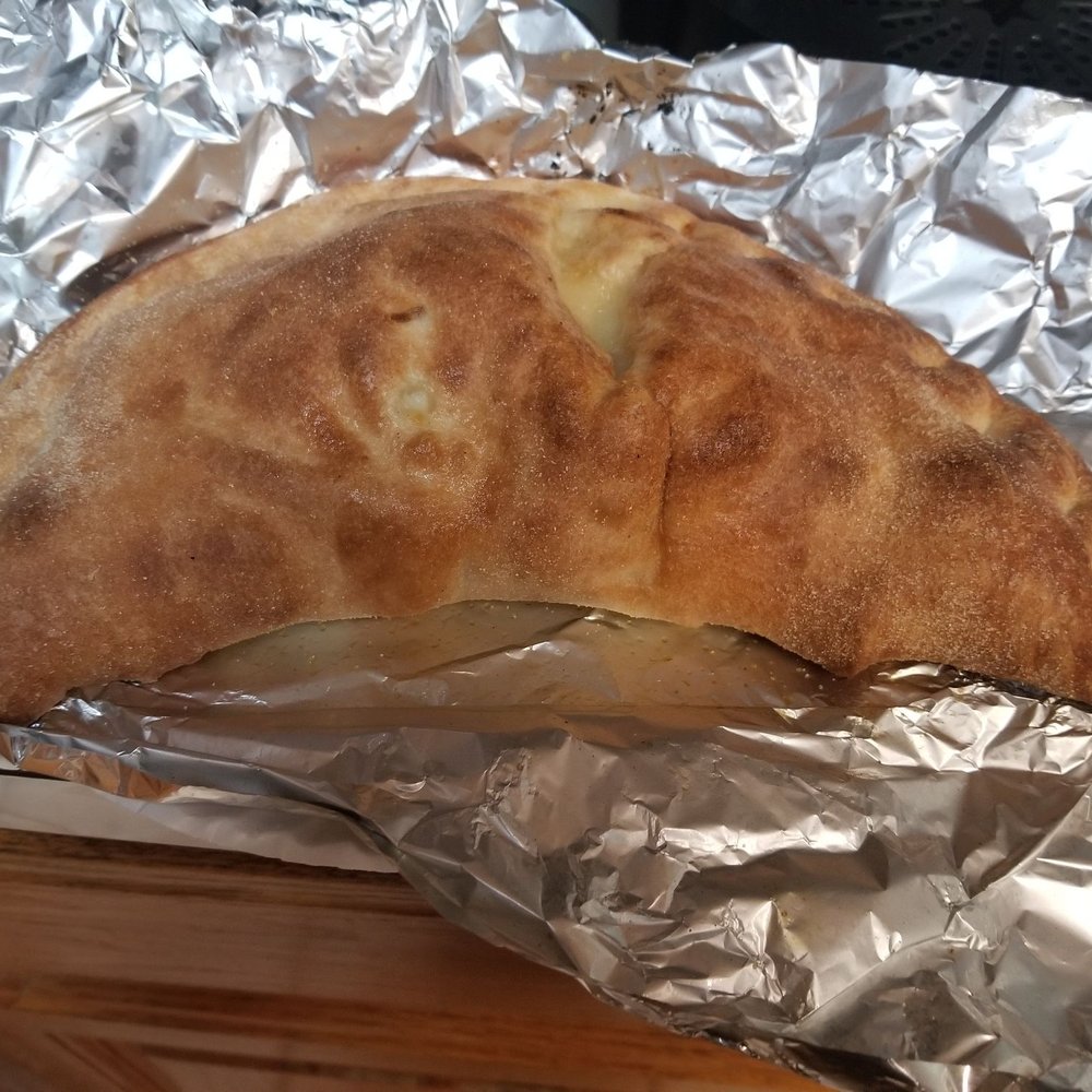 Calzone is served without sauce -- they wanted to charge me for sauce for the calzone.  Morons.