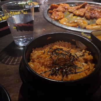 Sonu BBQ - Kimchi fried rice, with meats cooking in the background, and corn cheese on the top left. - Korean Near Me - Oceanside, California Sonu BBQ - Kimchi fried rice, with meats cooking in the background, and corn cheese on the top left. - Korean Near Me - Oceanside, California