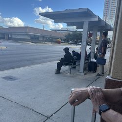 RedCoach - Time is 3:56. Other passengers waiting for the 3:10 bus.