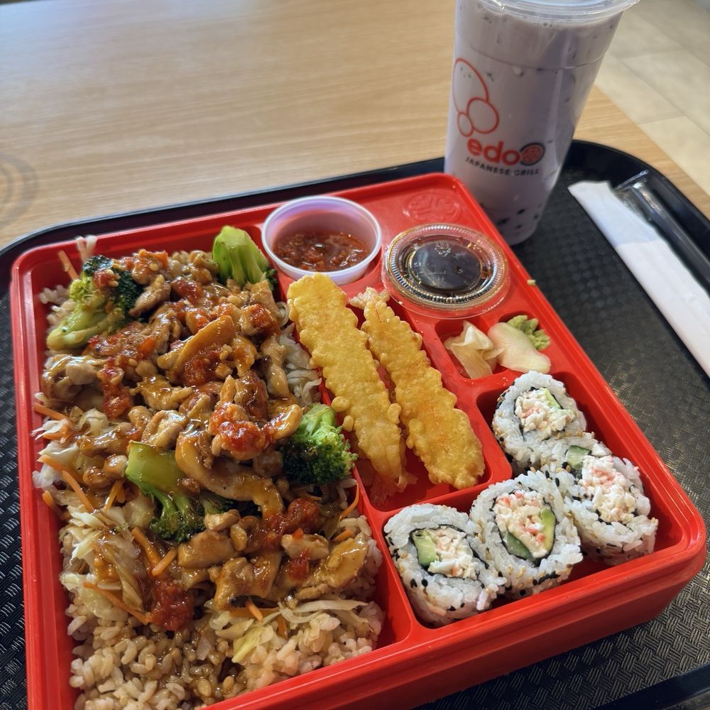 Chicken teriyaki bento with shrimp and sushi and taro boba drink. Chicken teriyaki bento with shrimp and sushi and taro boba drink.