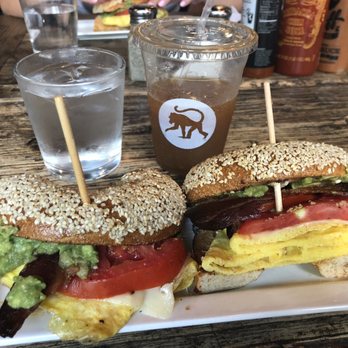 Frothy Monkey - egg & bacon sandwich on sesame bagel with avocado & tomato. iced coffee with almond milk - Coffee & Tea Near Me - Nashville, Tennessee