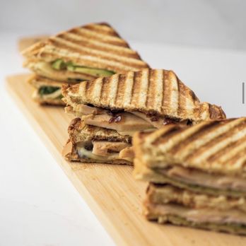 Jugo Juice - a stack of grilled sandwiches on a cutting board - Juice Bars & Smoothies Near Me - Langley, British Columbia Jugo Juice - a stack of grilled sandwiches on a cutting board - Juice Bars & Smoothies Near Me - Langley, British Columbia