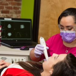 Braces By Dr. Ruth - Viviana scanning images of a patient's mouth