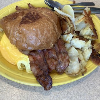 Mel's Diner - Bacon, Egg, Cheese breakfast croissant, with breakfast potatoes - Diners Near Me - Naples, Florida Mel's Diner - Bacon, Egg, Cheese breakfast croissant, with breakfast potatoes - Diners Near Me - Naples, Florida
