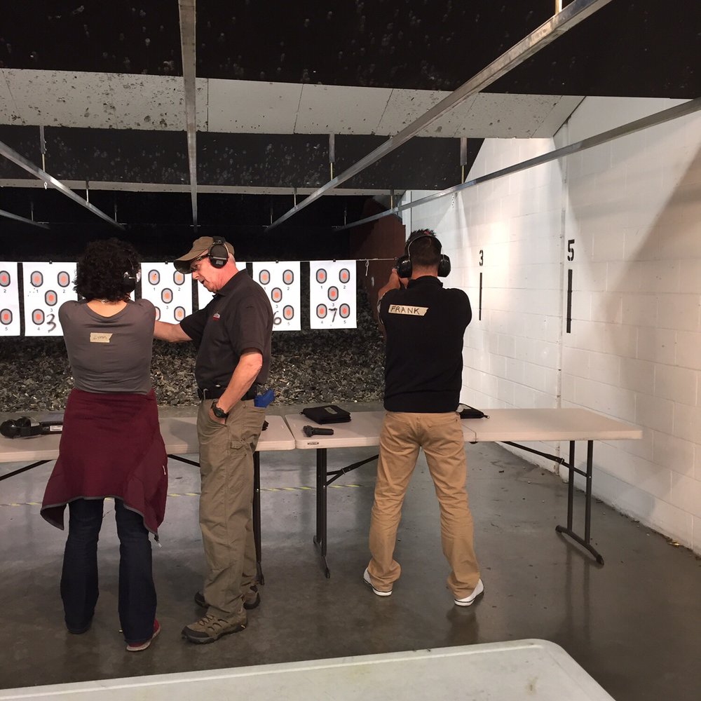 West Coast Armory North - The gentleman in the middle is Tracy coaching another student. - Guns & Ammo Near Me - Everett, Washington West Coast Armory North - The gentleman in the middle is Tracy coaching another student. - Guns & Ammo Near Me - Everett, Washington