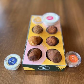 Dos Croquetas - a box of donuts on a table - Bakeries Near Me - Miami, Florida