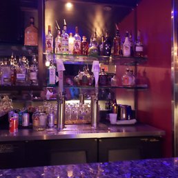 a bar with bottles of alcohol a bar with bottles of alcohol