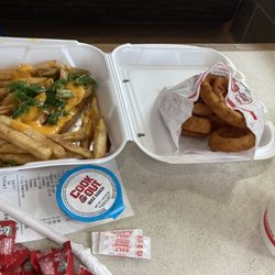 Cook Out - Jalapeño cheese fries on the left and onion rings on the right.