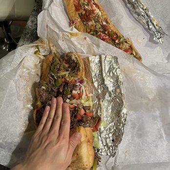 Carl's Steak Subs - Greco Chicken and Cheese Steak. Hand for scale. - Sandwiches Near Me - Waltham, Massachusetts