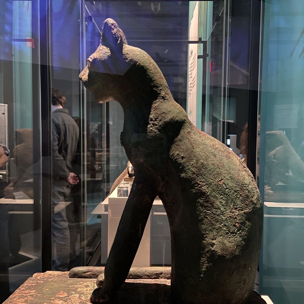 Pointe-à-Callière - Egypt: Three Millenia on the Nile: Statue of Bast, feline protective feminine deity - Museums Near Me - Montreal, Quebec Pointe-à-Callière - Egypt: Three Millenia on the Nile: Statue of Bast, feline protective feminine deity - Museums Near Me - Montreal, Quebec