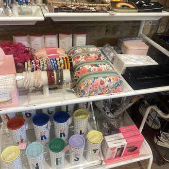 Art Effect - A retail store display shelf holds jewelry, small bags, and accessories, with various items including bracelets, pouches, and boxes. - Women's Clothing Near Me - Chicago, Illinois