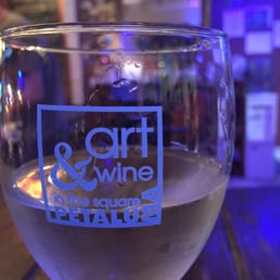 a glass of wine on a table a glass of wine on a table