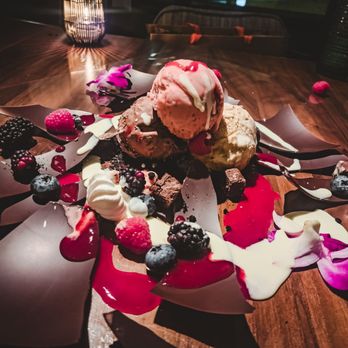 Toro Toro - La Bomba: chocolate half sphere / assorted ice creams / brownie / berry / crumble / vanilla and berry sauce - Steakhouses Near Me - Houston, Texas Toro Toro - La Bomba: chocolate half sphere / assorted ice creams / brownie / berry / crumble / vanilla and berry sauce - Steakhouses Near Me - Houston, Texas