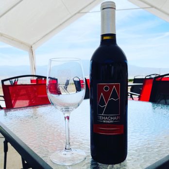 Tehachapi Winery - a bottle of wine and a glass on a table - Wineries Near Me - Tehachapi, California