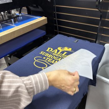 DTF Dallas - Heat press applying a DTF transfer onto apparel during custom t-shirt production at DTF Dallas in Richardson, Texas. - Screen Printing/T-Shirt Printing Near Me - Richardson, Texas DTF Dallas - Heat press applying a DTF transfer onto apparel during custom t-shirt production at DTF Dallas in Richardson, Texas. - Screen Printing/T-Shirt Printing Near Me - Richardson, Texas