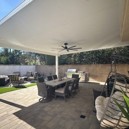 New Backyard landscaping with stone , patio, and fireplace .