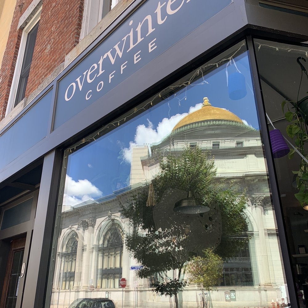 Overwinter Coffee - The reflection of the Buffalo Savings Bank building in the window. - Coffee & Tea Near Me - Buffalo, New York Overwinter Coffee - The reflection of the Buffalo Savings Bank building in the window. - Coffee & Tea Near Me - Buffalo, New York