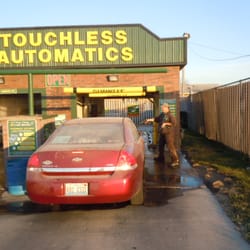 Hub City Car Wash - Attendant spraying for bugs and also the front wheels.