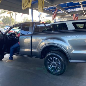 Encinitas Ford - Another side view , Moses looking inside the truck . - Car Dealers Near Me - Encinitas, California